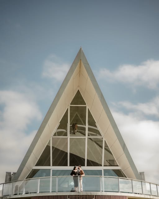 Couple photographed against striking chapel architecture