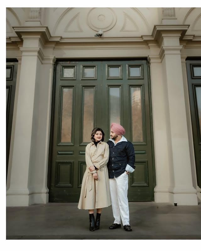 Sikh couple in front of grand heritage doors