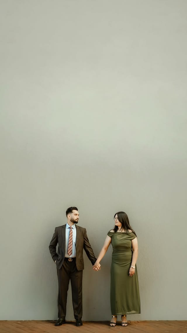 Couple holding hands in a contemporary editorial portrait
