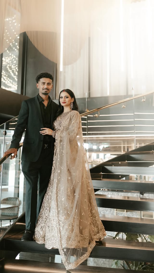 Elegantly dressed couple on a grand modern staircase